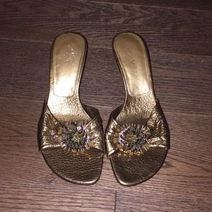 Shoes. Gold open toed heels with embellishment.